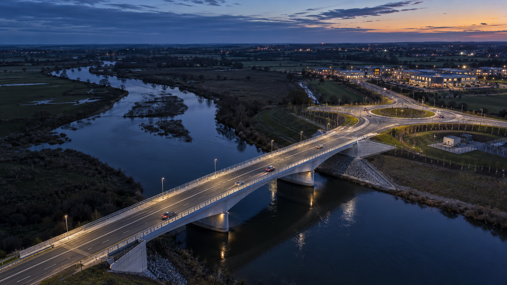 Bridge and infrastructure scheme across a river at dusk